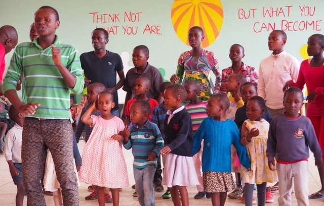 Charity partners dancing with children in Kenya